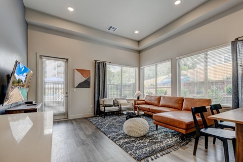 a living room with a couch and a table with chairs